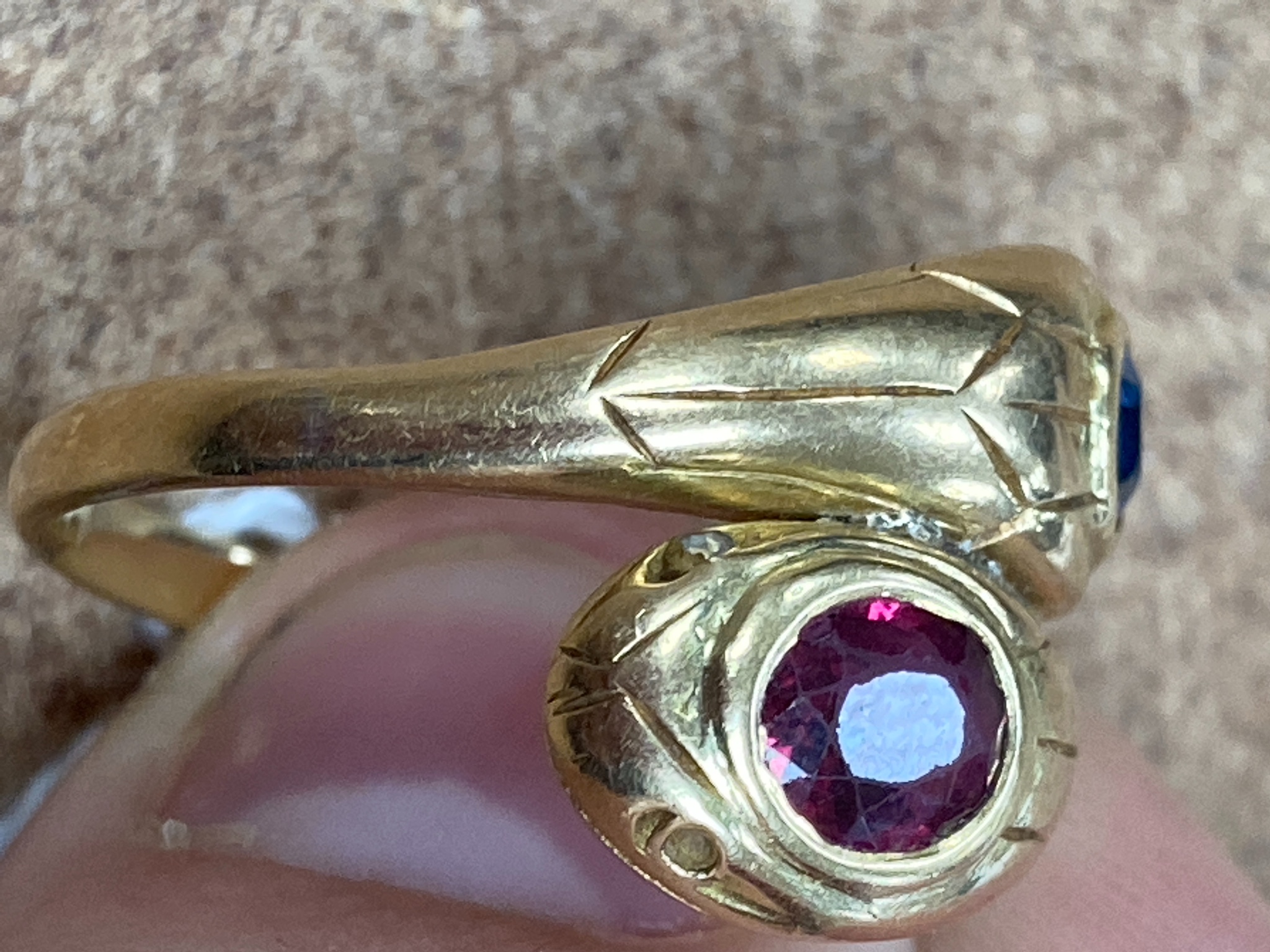 An 18ct yellow gold double 'cobra' ring, sapphire and ruby set, size Q/R, gross 7.6 grams.